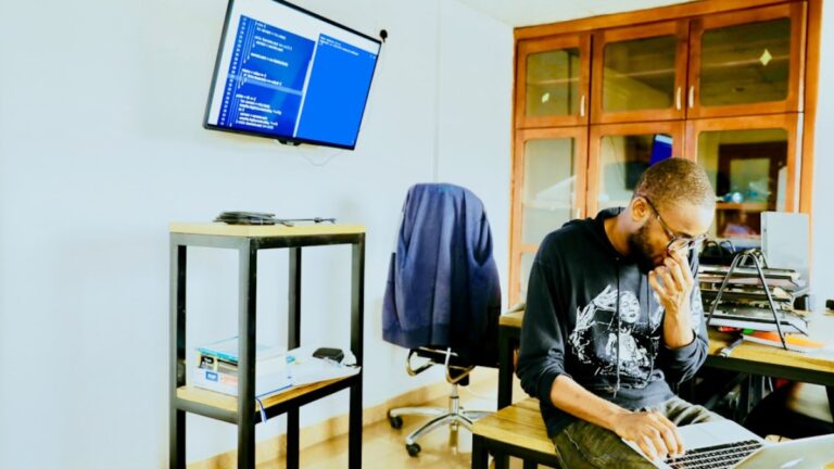 man using silver MacBook while sitting